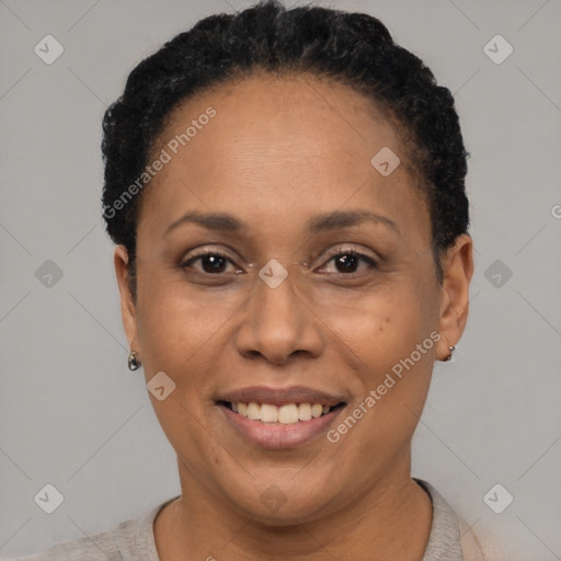 Joyful black adult female with short  black hair and brown eyes