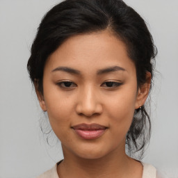 Joyful asian young-adult female with medium  brown hair and brown eyes