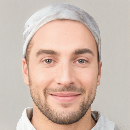 Joyful white young-adult male with short  black hair and brown eyes