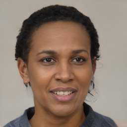 Joyful black adult female with short  brown hair and brown eyes