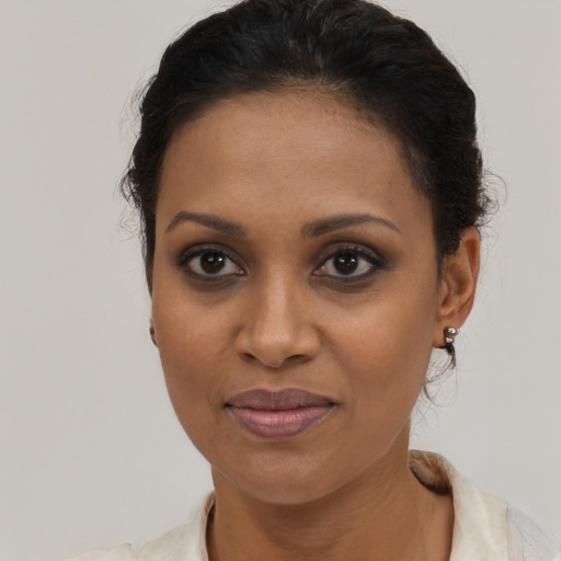 Joyful black young-adult female with short  brown hair and brown eyes