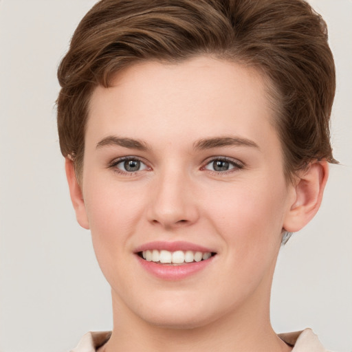 Joyful white young-adult female with short  brown hair and grey eyes