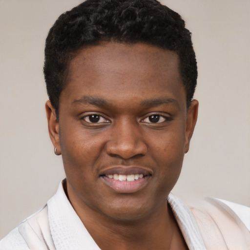 Joyful black young-adult male with short  brown hair and brown eyes