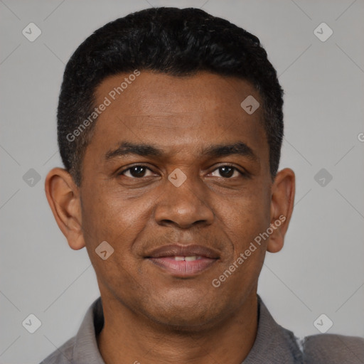 Joyful black young-adult male with short  black hair and brown eyes