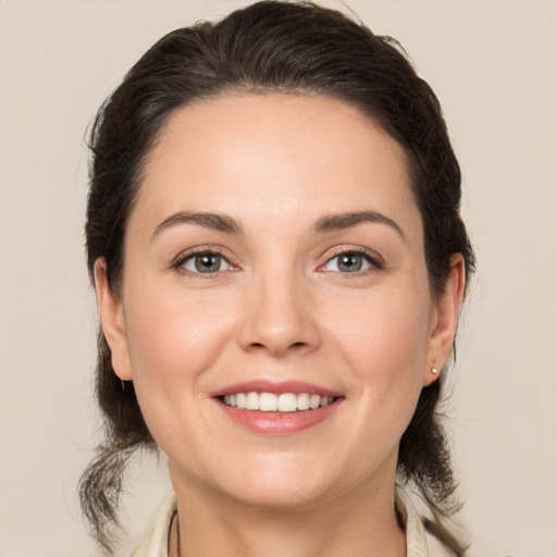 Joyful white young-adult female with medium  brown hair and brown eyes