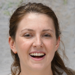 Joyful white adult female with medium  brown hair and grey eyes