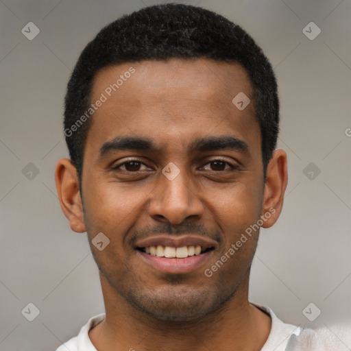 Joyful black young-adult male with short  black hair and brown eyes