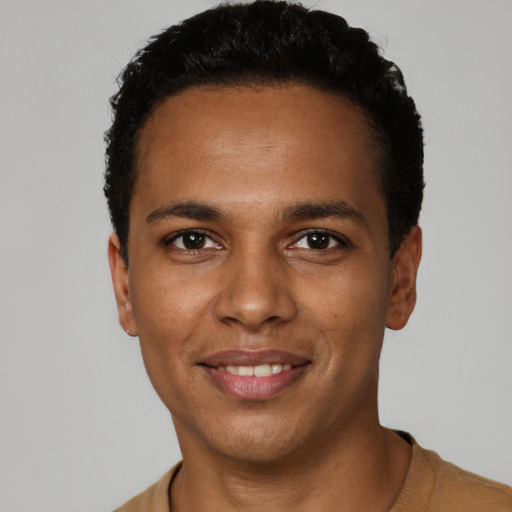 Joyful black young-adult male with short  black hair and brown eyes