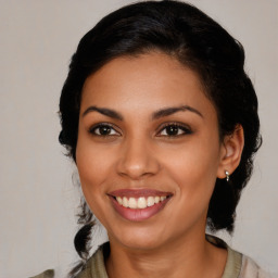 Joyful latino young-adult female with medium  brown hair and brown eyes