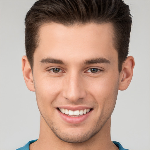 Joyful white young-adult male with short  brown hair and brown eyes