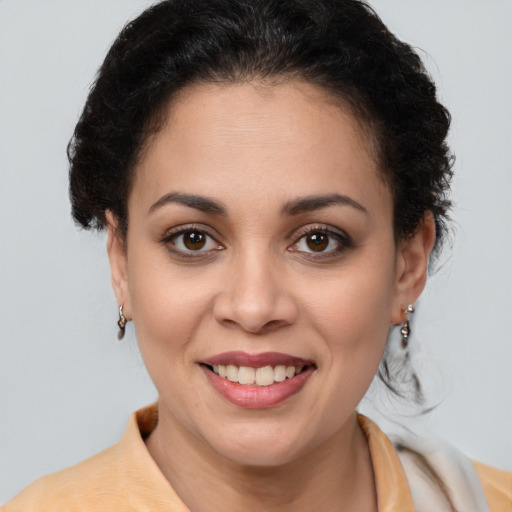 Joyful latino young-adult female with medium  brown hair and brown eyes