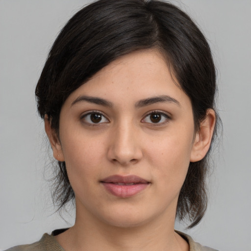 Joyful white young-adult female with medium  black hair and brown eyes