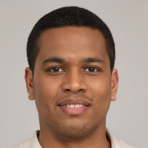 Joyful latino young-adult male with short  brown hair and brown eyes
