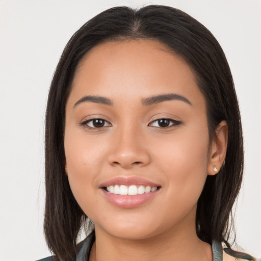 Joyful latino young-adult female with long  brown hair and brown eyes