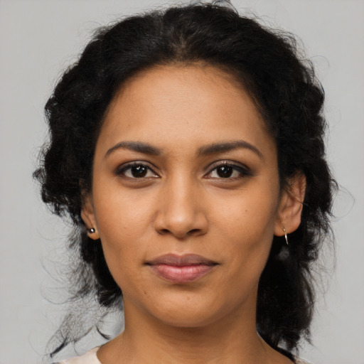 Joyful latino young-adult female with medium  brown hair and brown eyes