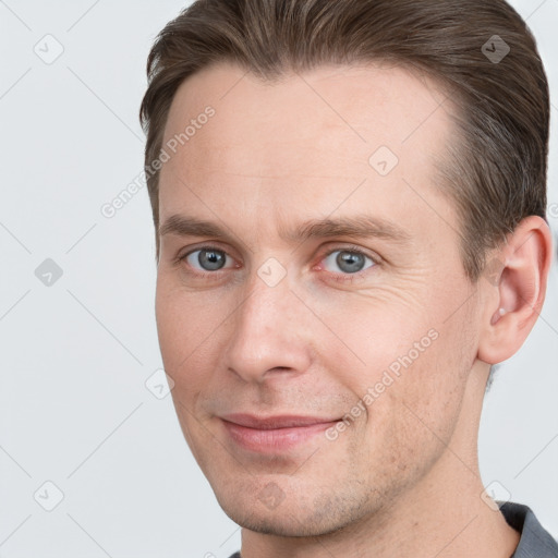 Joyful white adult male with short  brown hair and grey eyes