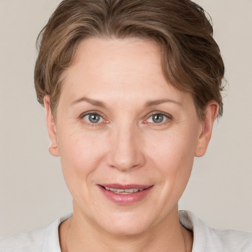 Joyful white adult female with short  brown hair and grey eyes