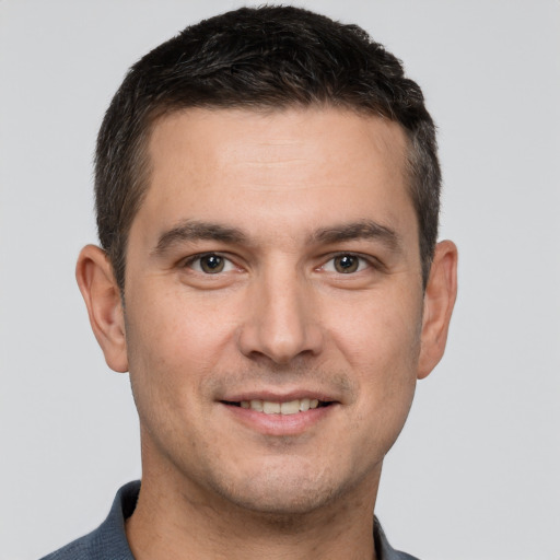 Joyful white young-adult male with short  brown hair and brown eyes