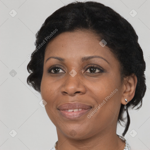 Joyful black adult female with short  brown hair and brown eyes