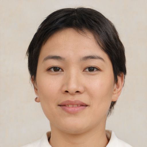 Joyful asian young-adult female with medium  brown hair and brown eyes