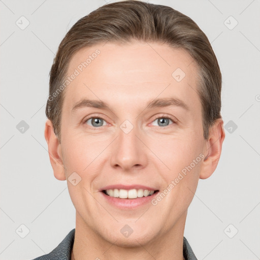 Joyful white young-adult male with short  brown hair and grey eyes