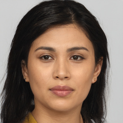 Joyful asian young-adult female with long  brown hair and brown eyes