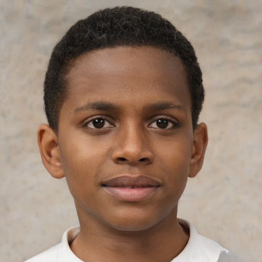 Joyful black child male with short  brown hair and brown eyes