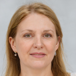 Joyful white adult female with long  brown hair and grey eyes