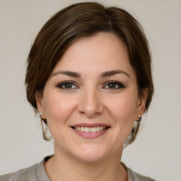 Joyful white young-adult female with medium  brown hair and brown eyes