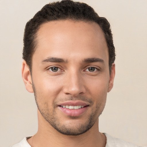 Joyful white young-adult male with short  brown hair and brown eyes