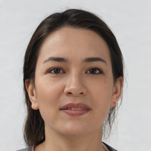 Joyful white young-adult female with medium  brown hair and brown eyes