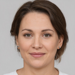 Joyful white adult female with medium  brown hair and brown eyes