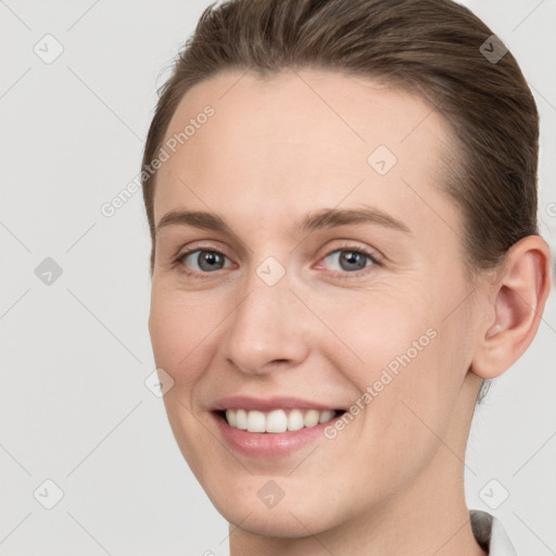 Joyful white young-adult female with short  brown hair and grey eyes