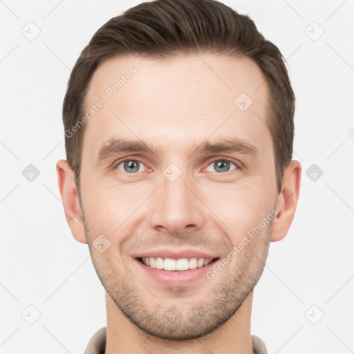 Joyful white young-adult male with short  brown hair and grey eyes