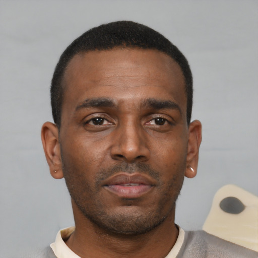 Neutral black young-adult male with short  black hair and brown eyes