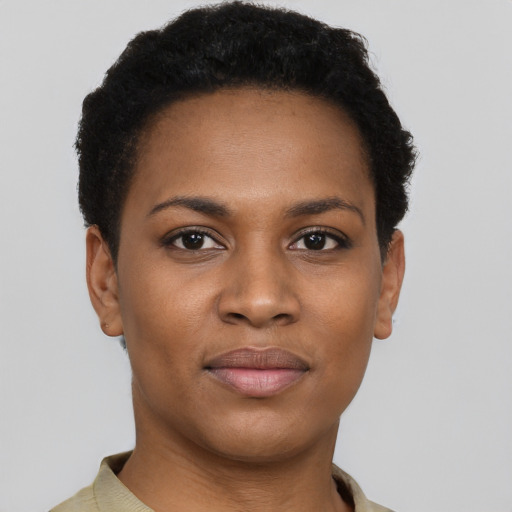Joyful black young-adult female with short  black hair and brown eyes