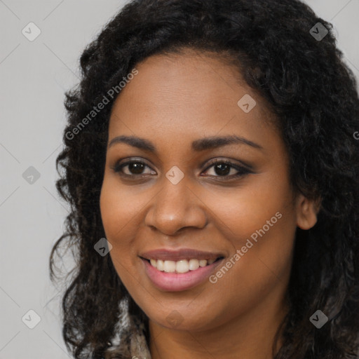 Joyful black young-adult female with long  black hair and brown eyes