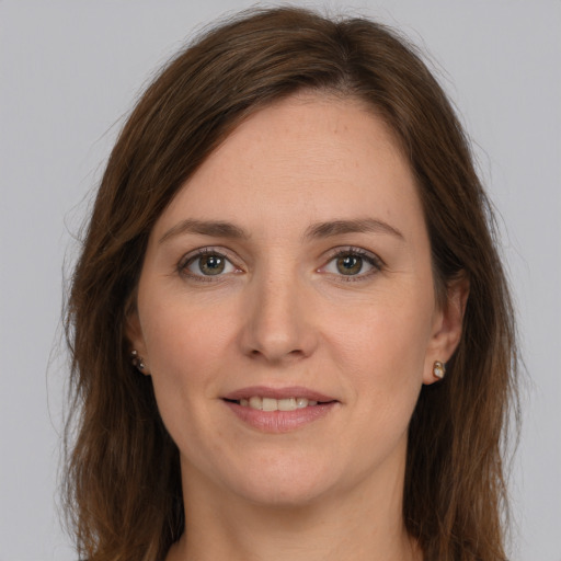 Joyful white young-adult female with long  brown hair and grey eyes