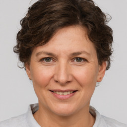 Joyful white adult female with short  brown hair and brown eyes