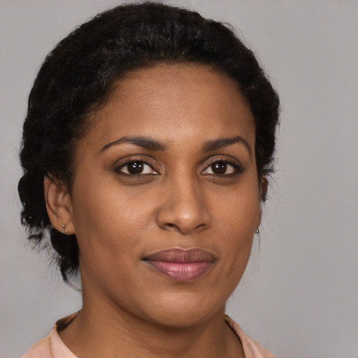 Joyful black young-adult female with medium  brown hair and brown eyes