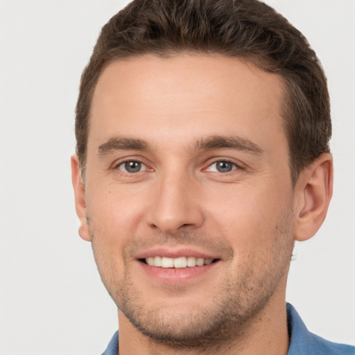 Joyful white young-adult male with short  brown hair and brown eyes