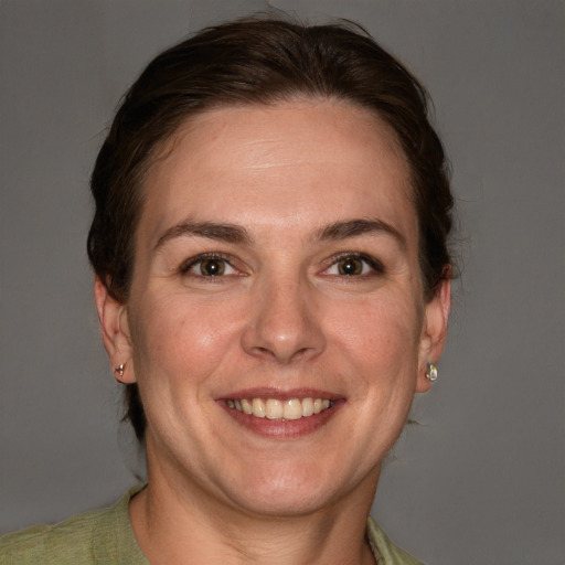 Joyful white adult female with short  brown hair and grey eyes