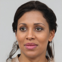 Joyful black adult female with medium  brown hair and brown eyes