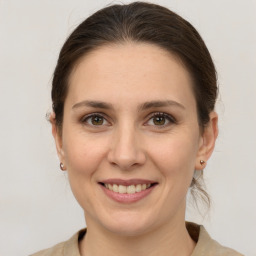 Joyful white adult female with medium  brown hair and grey eyes