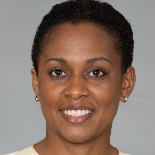 Joyful black young-adult female with short  brown hair and brown eyes