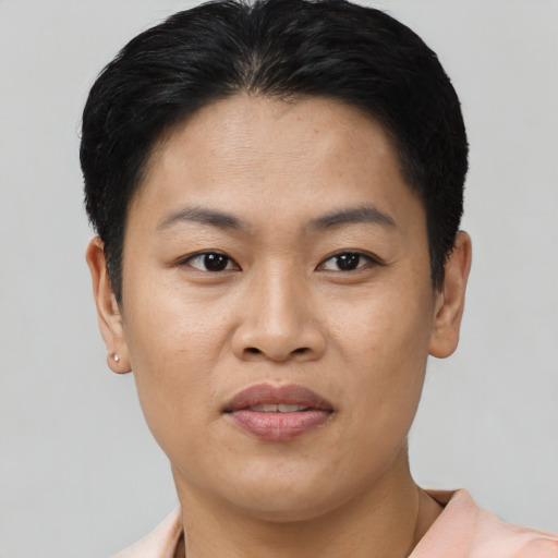 Joyful asian young-adult female with short  black hair and brown eyes