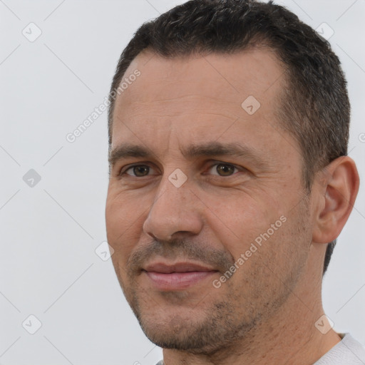 Joyful white adult male with short  brown hair and brown eyes