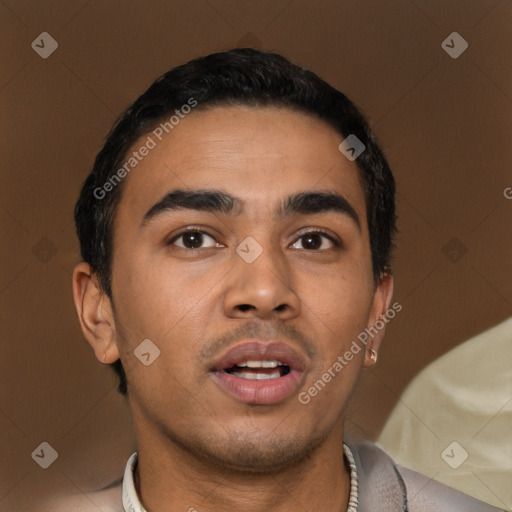 Joyful latino young-adult male with short  brown hair and brown eyes