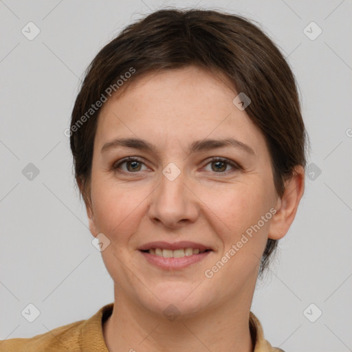 Joyful white adult female with short  brown hair and grey eyes