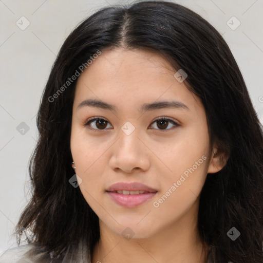 Joyful latino young-adult female with long  brown hair and brown eyes